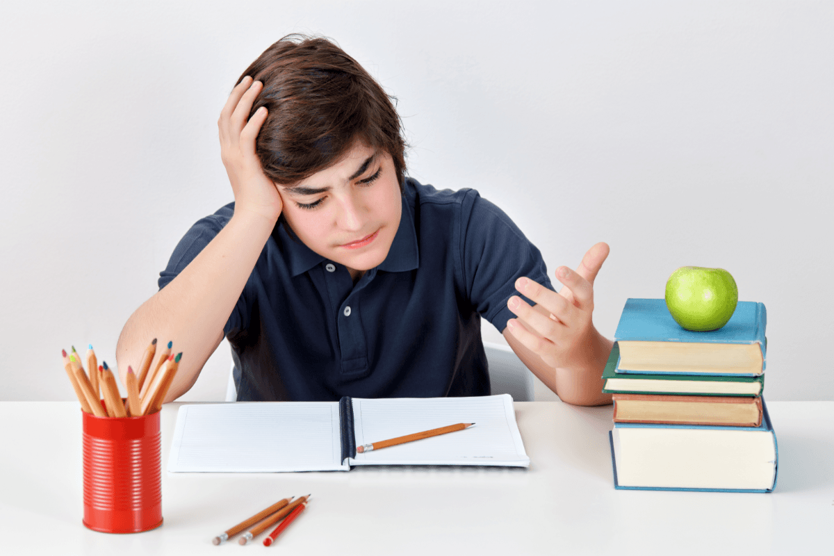 Boy studying feeling angry and confused