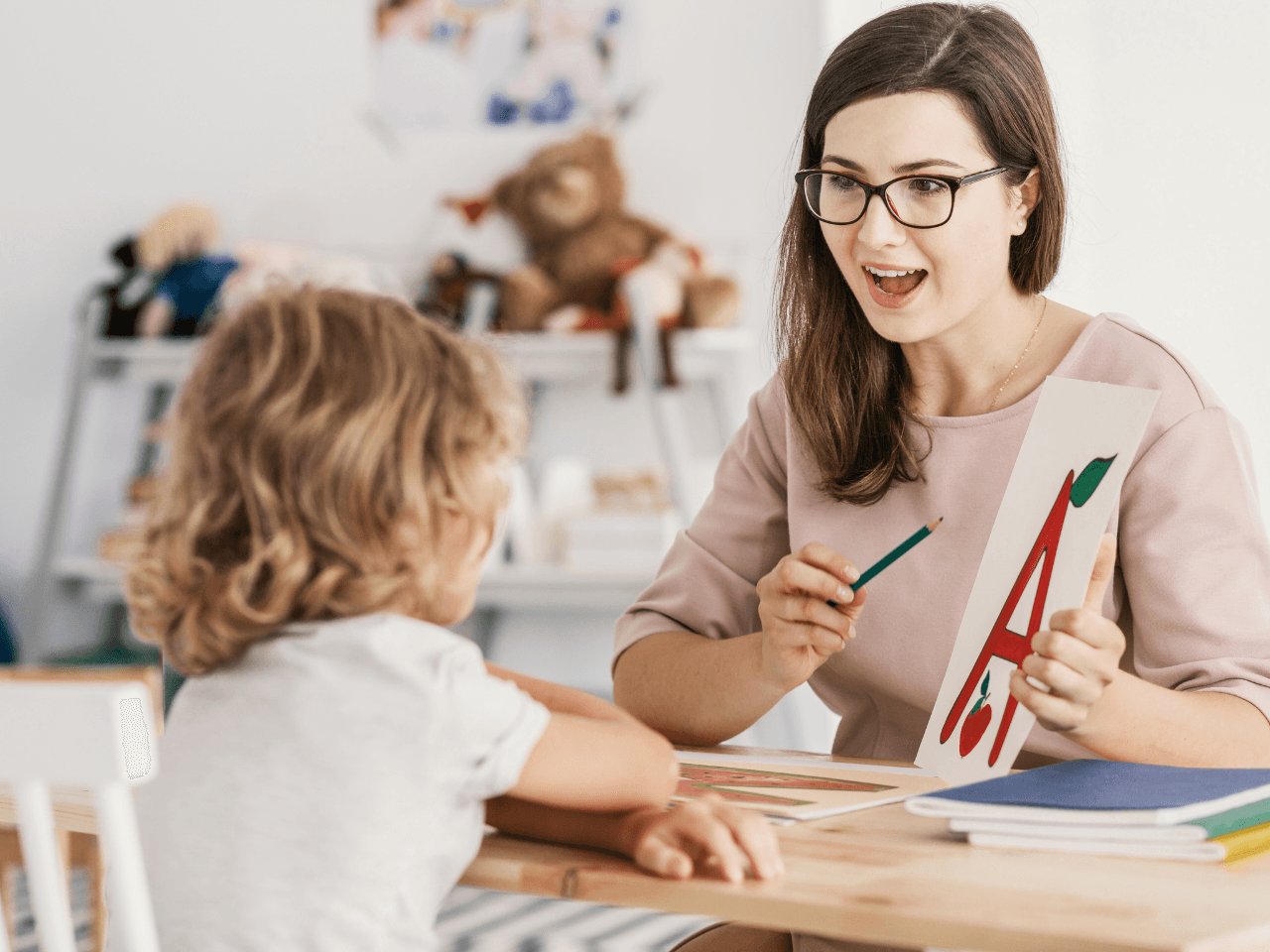 Young girl learning to say the letters