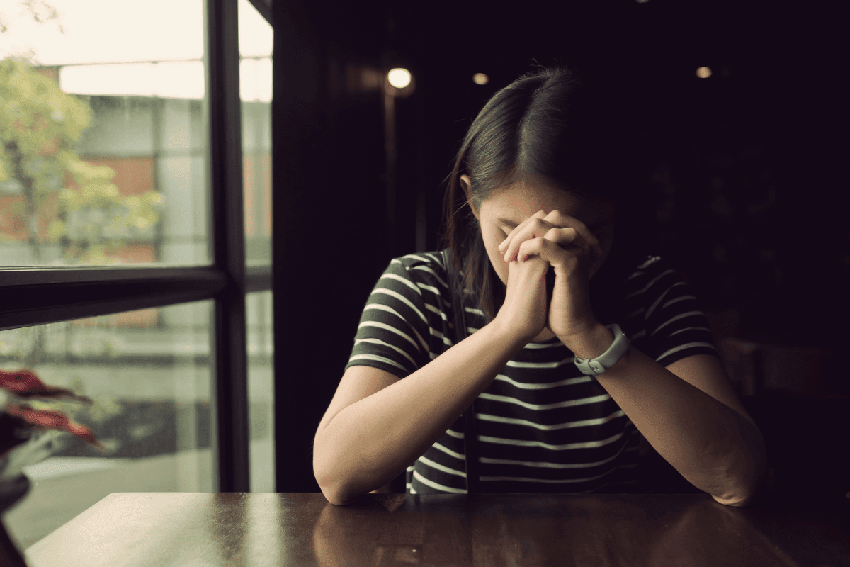 Girl in distress with hands on head
