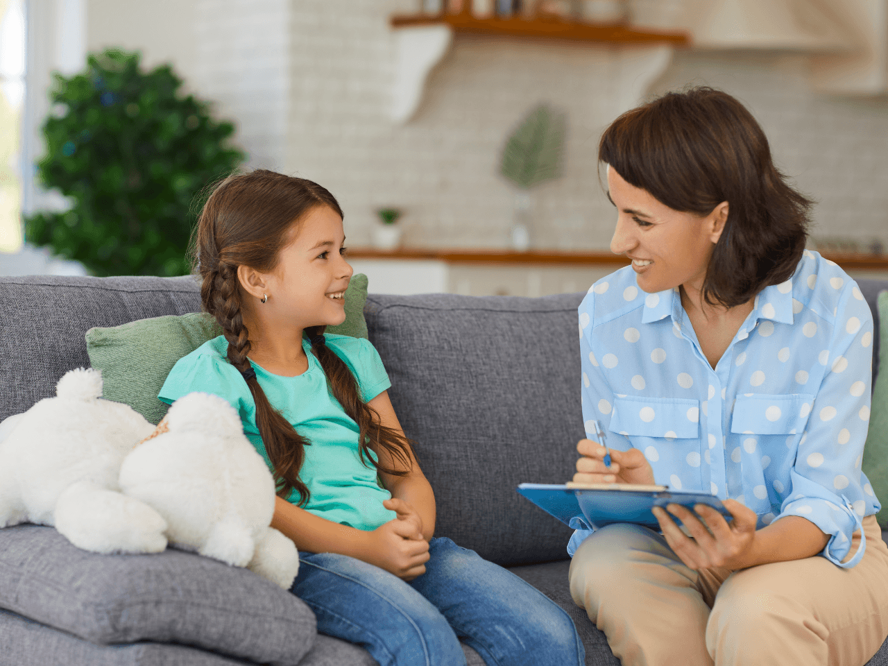 therapist sitting with child on couch