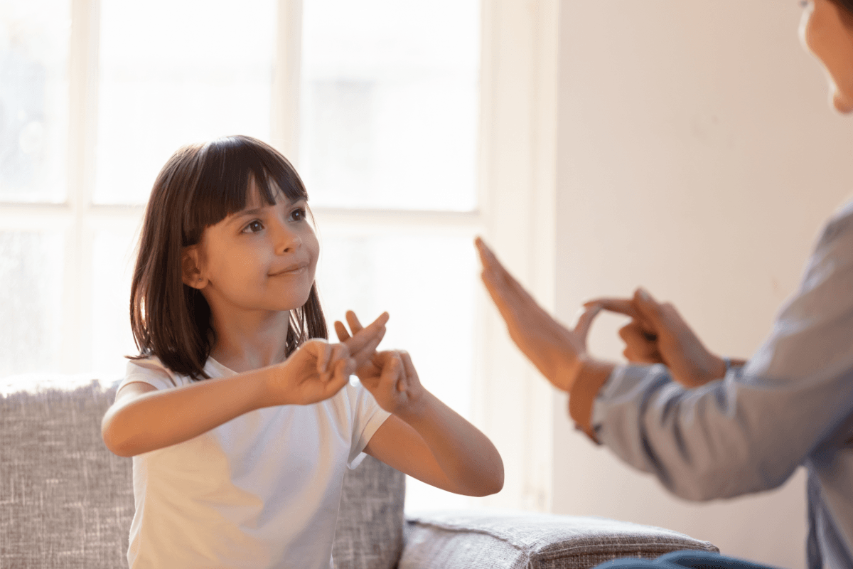 Young girl using sign language