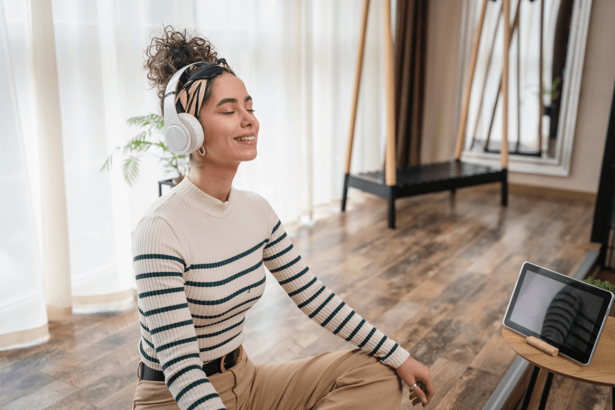 Woman listening to music and doing yoga